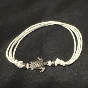 Silver Turtle Charm on White Bracelet